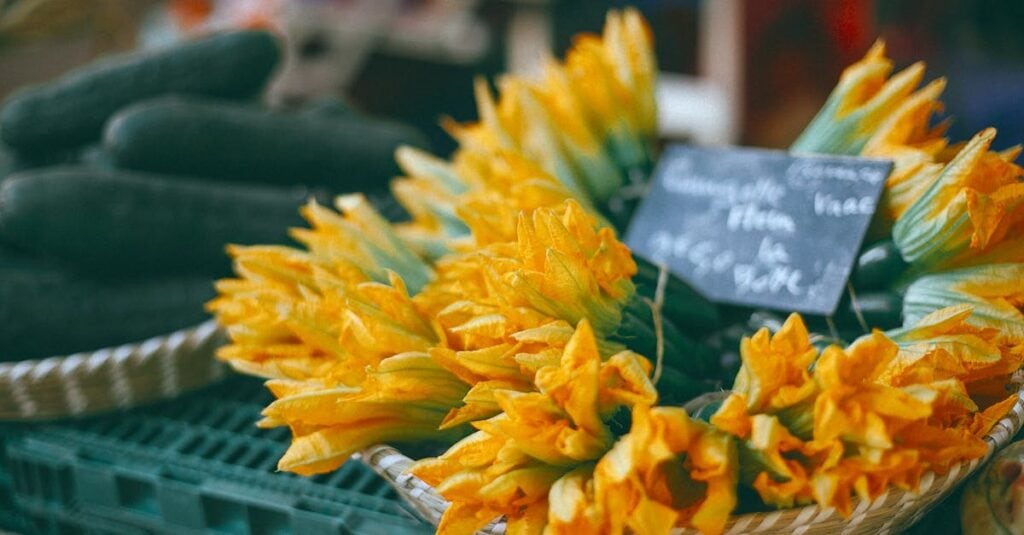 Vibrant zucchini flowers displayed at a market for sale. Ideal for recipes and nutrition.